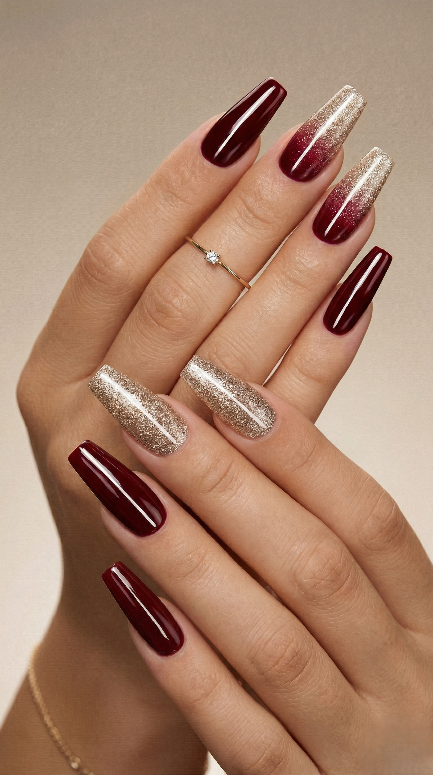 Deep burgundy coffin nails with champagne gold glitter accent